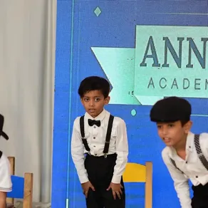 Students perform in front of the Annual Function stage backdrop