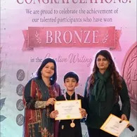 A Spring Buds student receives a Bronze award at Create for Peace 2026