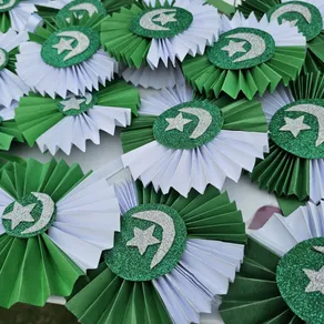 Handmade paper rosettes with crescent and star made by Spring Buds students