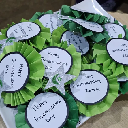 Student-made "Happy Independence Day" badges ready for the school celebration